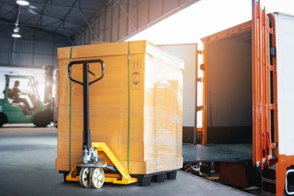 Forklift adjusting palletized freight in a trailer