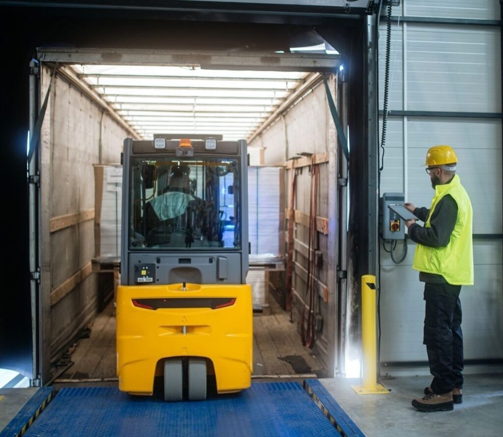 Workers restacking a shifted pallet load